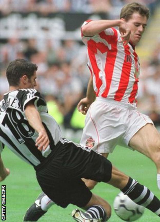 Aaron Hughes tackles Kevin Kilbane