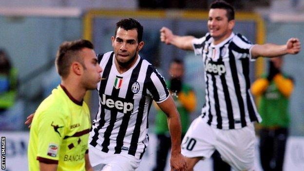 Juventus forward Carlos Tevez scores against Livorno