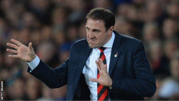 Cardiff manager Malky Mackay gesticulates to his players during the 3-0 defeat against Arsenal