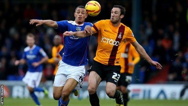 Jonson Clarke-Harris battles for possession