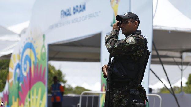 A soldier secures the entrance of the draw hall before the draw for the 2014 soccer World Cup in Costa do Sauipe