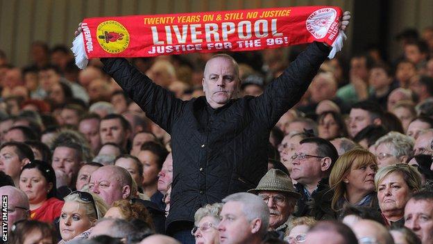 A Liverpool fan at Anfield marking the 24th anniversary of the Hillsborough disaster