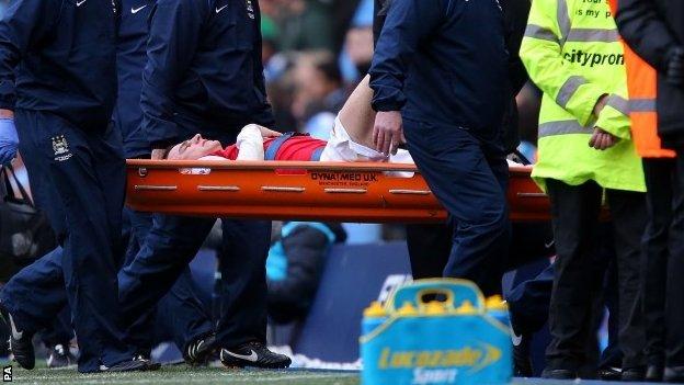 Arsenal's Laurent Koscielny is stretchered off