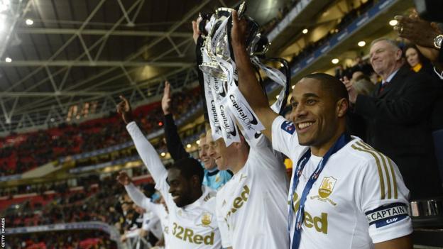 Swansea City's Ashley Williams and Garry Monk hold aloft the Football League Trophy at Wembley following their 5-0 final win over Bradford City.