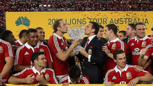 Injured Lions captain Sam Warburton and stand-in skipper Alun Wyn Jones kiss the glass trophy after the third Test win over Australia which clinched the series.