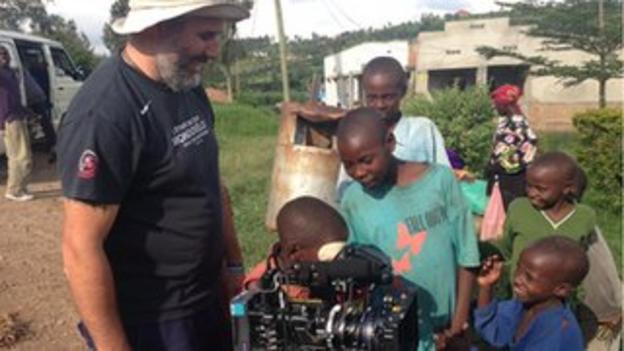 Cameraman with locals in Rwanda