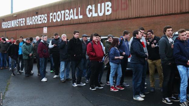 Kidderminster fans line up to enter the stadium