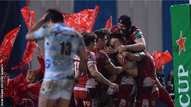 Scarlets players celebrate Kristian Phillips' try against Racing Metro