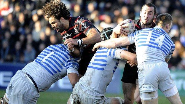 Toulouse scrum-half Jean-Marc Doussain is tackled by Saracens wing Chris Ashton, among others