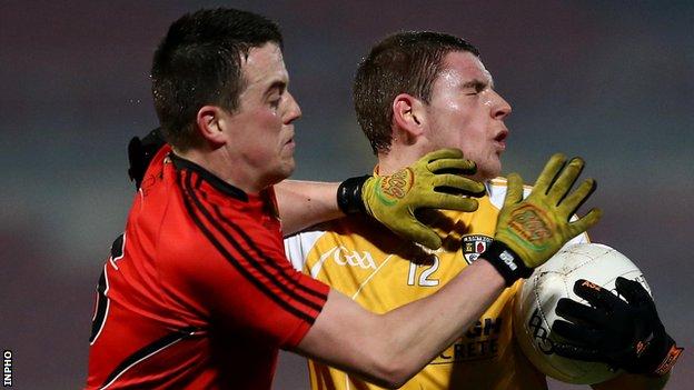 Down's Conor Garvey challenges Antrim's Paddy Kelly