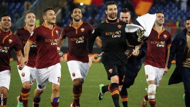 Roma's Francesco Totti (third left) celebrates with his teammates after winning their Italian Serie A soccer match against Livorno