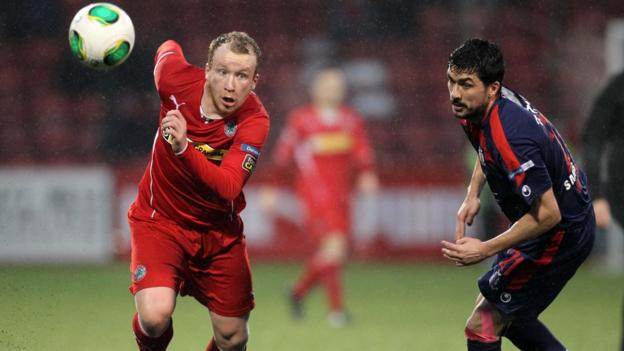 Cliftonville striker Liam Boyce looks favourite to get to the ball ahead of Portadown defender Emmett Friars at Solitude