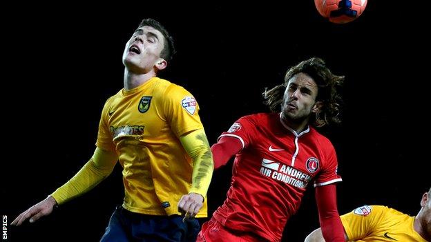 Oxford United's Josh Ruffels and Charlton Athletic's Diego Poyet (right) battle for the ball