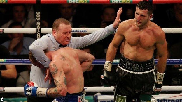 Referee Howard Foster stops Carl Froch (right) and George Groves in their WBA and IBF Super Middleweight title fight against George Groves