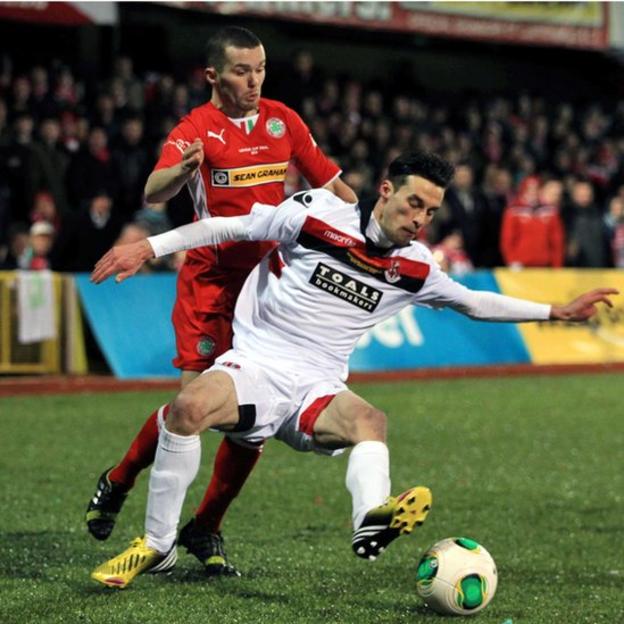 Cliftonville's Martin Donnelly moves in to challenge Crusaders midfielder Declan Caddell