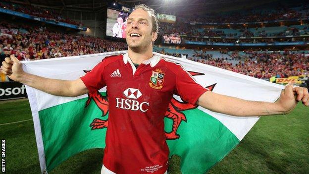 Alun Wyn Jones drapes himself in a Welsh flag after captaining the Lions to victory over Australia