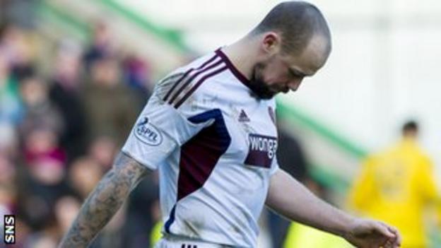Hearts midfielder Jamie Hamill is dejected after seeing his penalty saved