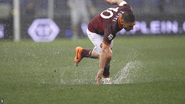AS Roma forward Francesco Totti falls on the slippery field
