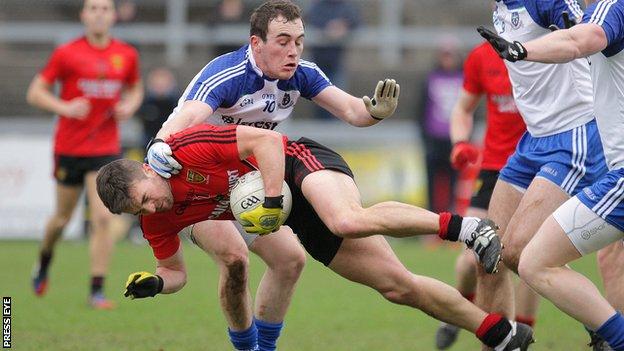 Down's Mark Poland hits the deck under pressure from Padraic Keenan of Monaghan