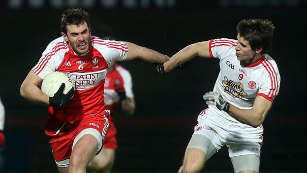 Derry's Mark Lynch attempts to make ground at the expense of Tyrone's Conon Grugan in Saturday night's Division One game
