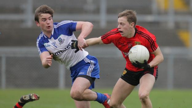 Monaghan's Dessie Mone is shrugged off by Down's Jerome Johnston in the Division Two clash at Pairc Esler