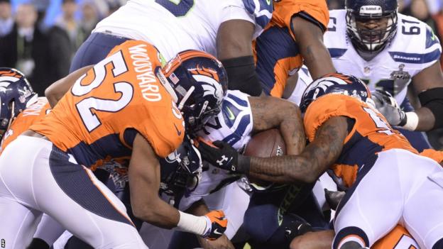 Seattle running back Marshawn Lynch bulldozes his way into the Denver endzone for Super Bowl XLVIII's first touchdown