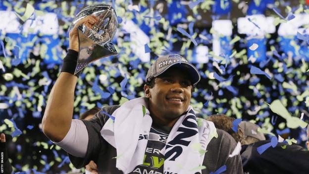 Quarterback Russell Wilson of the Seattle Seahawks celebrates with the Vince Lombardi Trophy after their 43-8 victory over the Denver Broncos in Super Bowl XLVIII