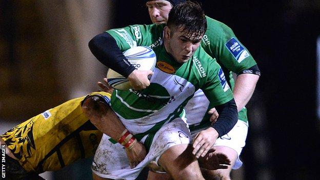 George McGuigan (centre) of Newcastle Falcons is tackled by Alexandru Miti of Bucharest Wolves