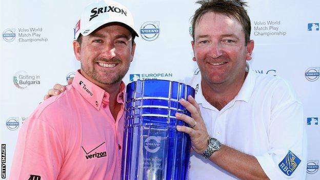Graeme McDowell and caddie Ken Comboy with the Volvo World Matchplay Championship trophy