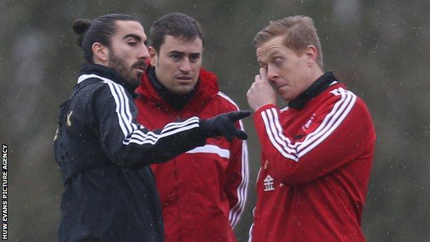 Chico Flores talking to Swansea manager Garry Monk
