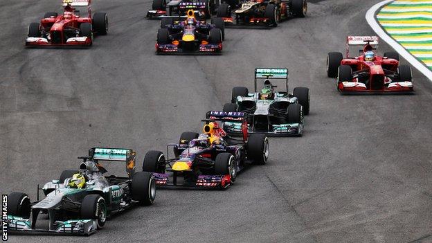 Nico Rosberg of Germany and Mercedes GP takes the lead from Sebastian Vettel of Germany and Infiniti Red Bull Racing at the start of the Brazilian Formula One Grand Prix 2013.