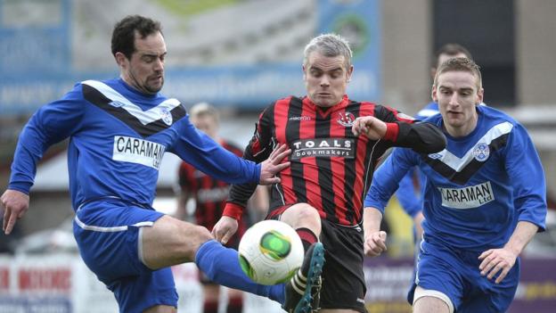 Diarmud Larkin challenges Gary McCutcheon during Crusaders' 4-0 win over Ballymoney United at Seaview