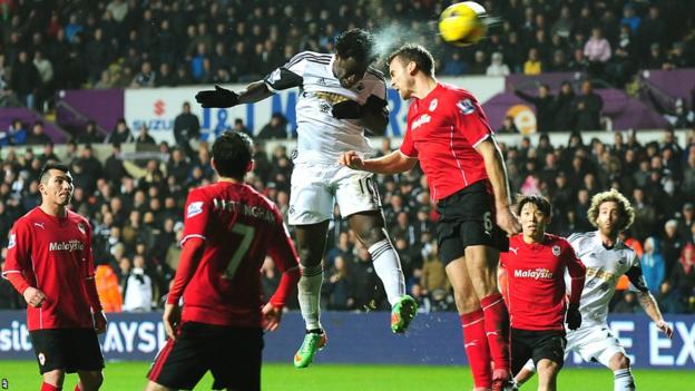 Wilfried Bony rises above Ben Turner to cap a 3-0 victory for Swansea over Cardiff