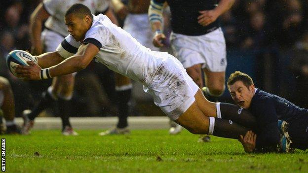 Luther Burrell dives over to score England's opening try at Murrayfield
