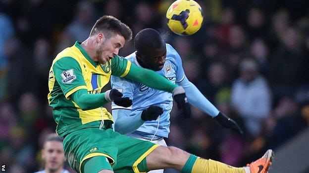 Manchester City midfielder Yaya Toure (right) and Norwich striker Ricky van Wolfswinkel go up for a header in the 0-0 draw between the two sides at Carrow Road
