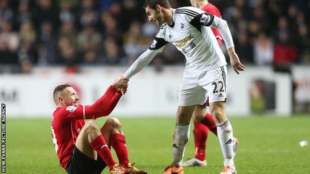 Cardiff's Craig Bellamy and Angel Rangel of Swansea share a more light-hearted moment during the south Wales derby