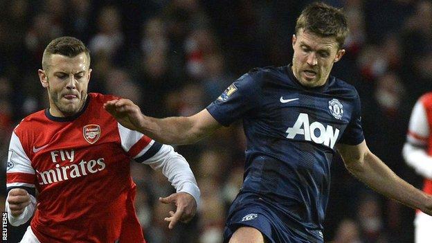 Arsenal midfielder Jack Wilshere and Manchester United midfielder Michael Carrick fight for the ball