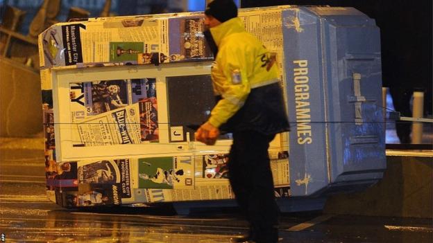 Manchester City's programme kiosk takes a tumble