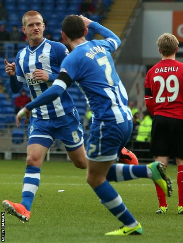 But Ben Watson (left) celebrates the winner for Wigan at Cardiff City Stadium