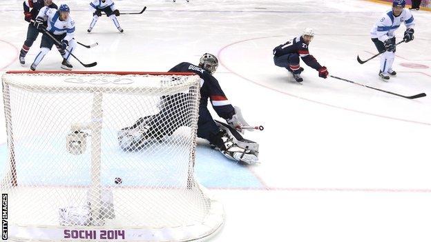 Teemu Selanne #8 of Finland shoots and scores against Jonathan Quick