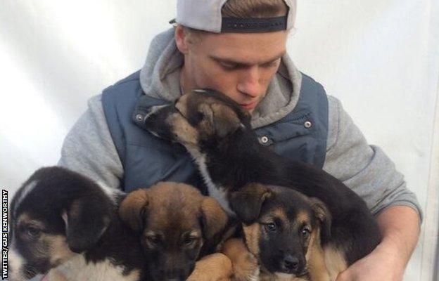 Gus Kenworthy with puppies