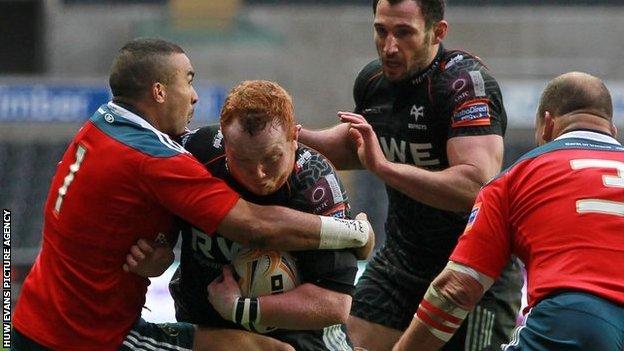 Munster wing Simon Zebo brings down Ospreys prop Dan Suter in the Pro12 at Liberty Stadium