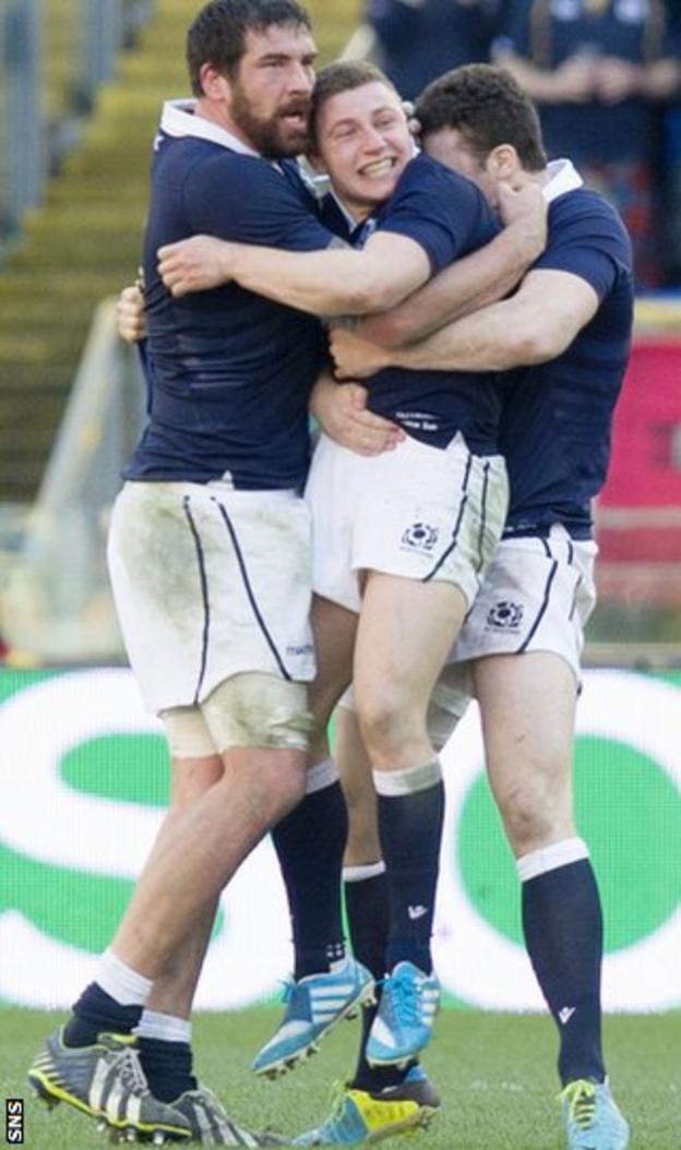Duncan Weir (centre) celebrates after winning the game in Italy