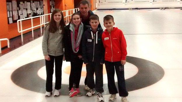 Kids and father after curling lesson