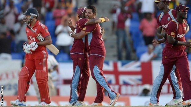 Ravi Bopara of England leaves the field as Dwayne Bravo and Ravi Rampaul of the West Indies celebrates