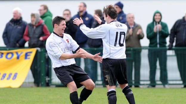 Mark Prenter is congratulated after scoring one of his two free-kick goals in Queen's University's 3-2 win over Bangor