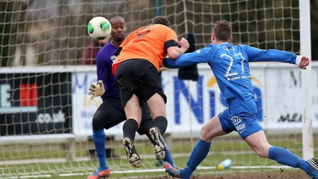 Striker Guy Bates heads home one of his three goals for the Lurgan Blues against the Mallards