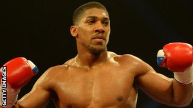 Anthony Joshua celebrates beating Hector Avila