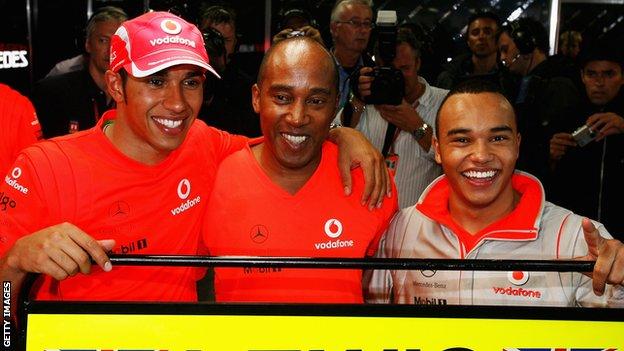 Lewis Hamilton with his father and brother