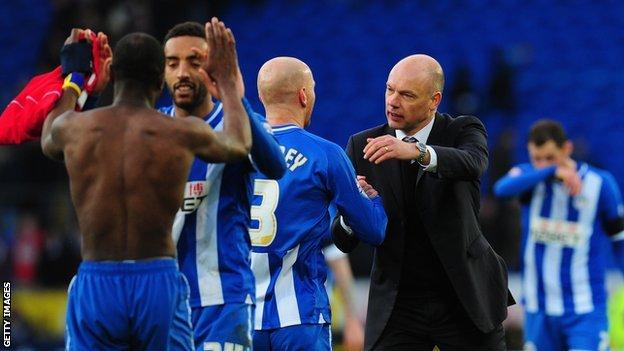 Wigan boss Uwe Rosler and his players celebrate their FA Cup quarter final win at Manchester City